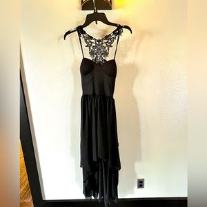 Beautiful detailed black dress with stunning back design.